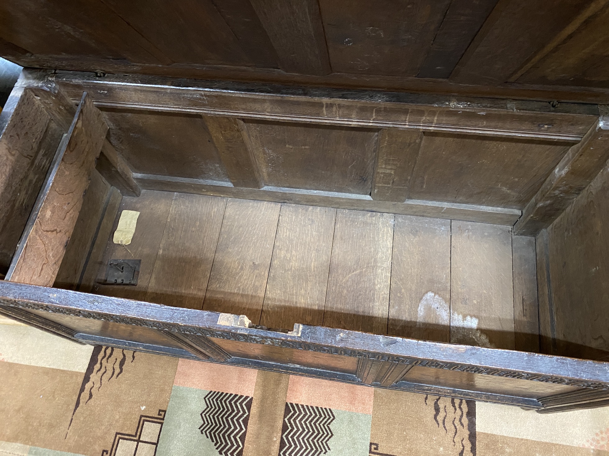 A 17th century inlaid oak panelled coffer, width 139cm, depth 56cm, height 64cm